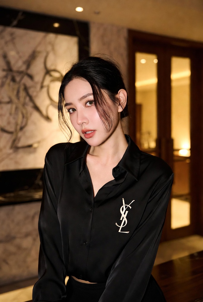 Elegant model wearing an authentic Yves Saint Laurent Silk Blouse crafted from premium mulberry silk with signature YSL monogram hardware, relaxed fit, and timeless Parisian luxury styling.