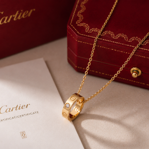 Cartier Gold Pendant Necklace displayed in luxury gift box with elegant gold chain and pendant.