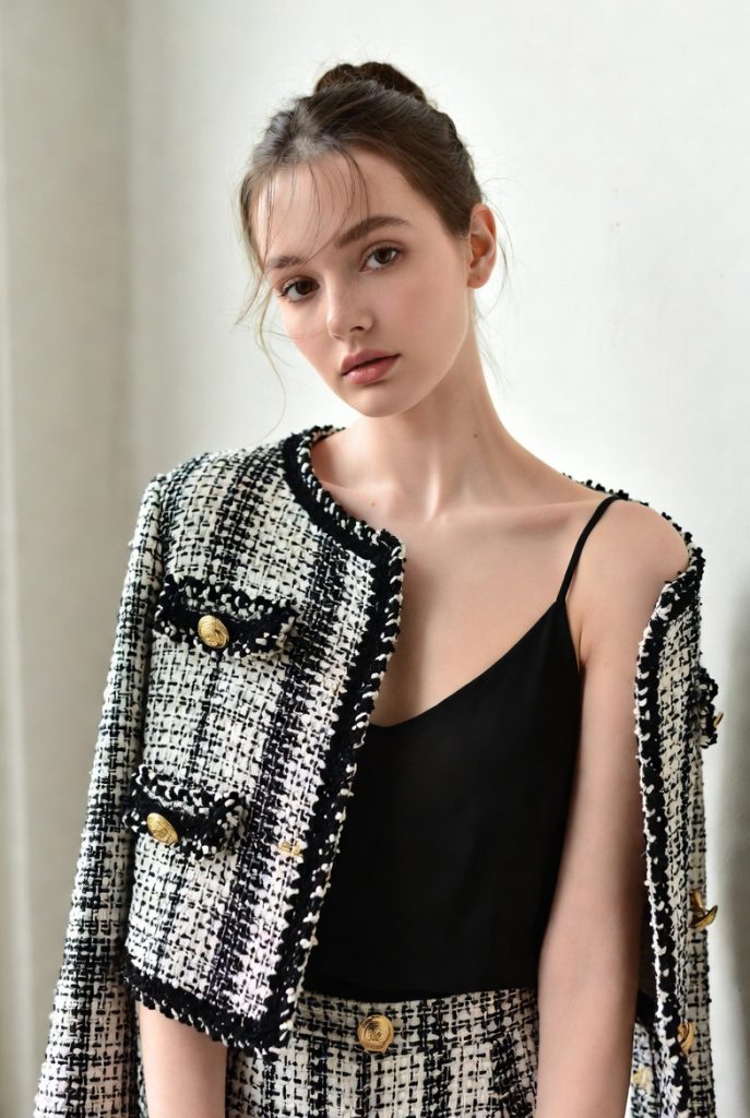 Elegant woman in classic Chanel tweed bouclé jacket, luxury fashion outerwear