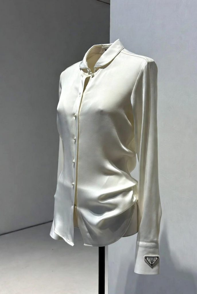 Prada white silk blouse for women with tailored fit and subtle logo cuff detail
