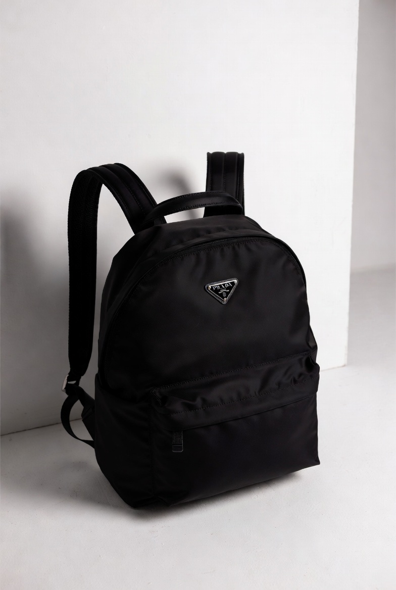 Prada Re-Nylon backpack crafted from sustainable recycled nylon with leather trim and signature logo